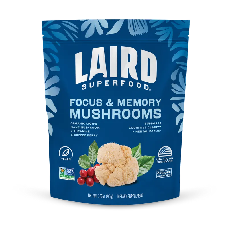 The blue 3.17-ounce bag of Laird Superfood Focus and Memory Mushrooms beside a glass of coffee, from the seller's photograph